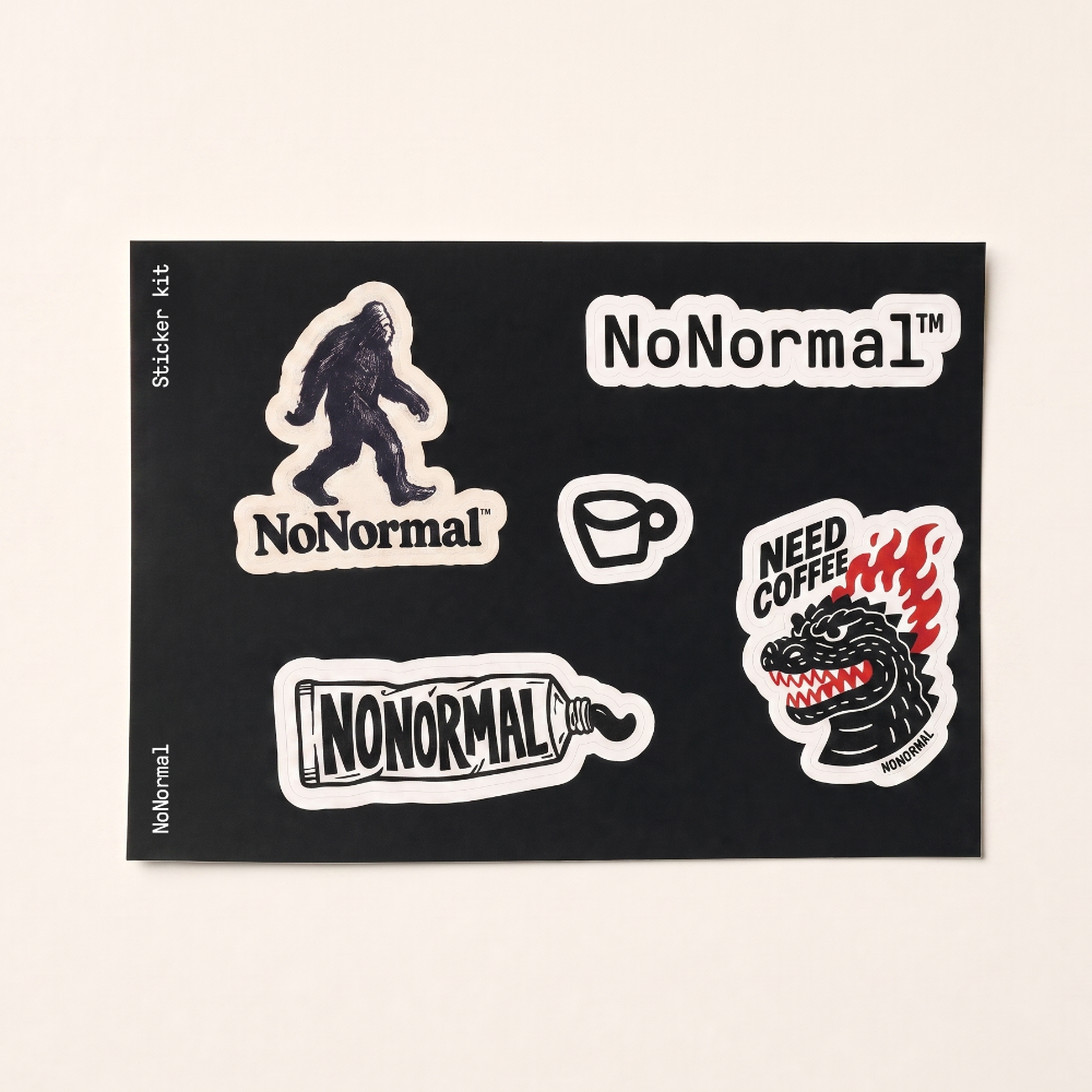 A sticker kit sheet featuring various 'NoNormal' themed stickers, including a Bigfoot silhouette, a coffee cup, a monster head with flames, and a pill bottle, all on a black backing card against a light beige background.