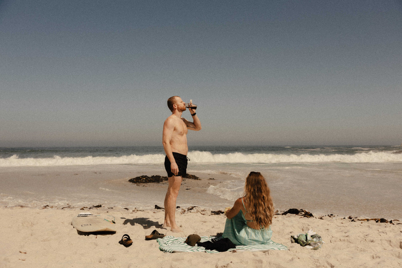 Mixing cold NoNormal coffee in a Nalgene bottle outdoors.