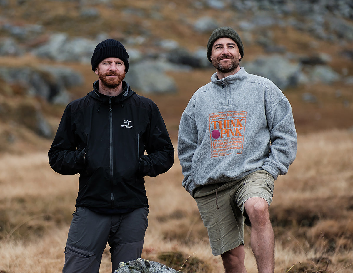 Alexander and Philippe, the founders of NoNormal, standing outdoors in the mountains